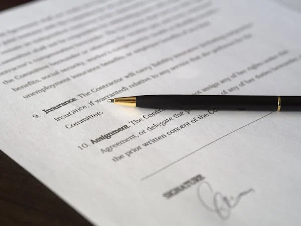 Close-up of contract document with black pen
