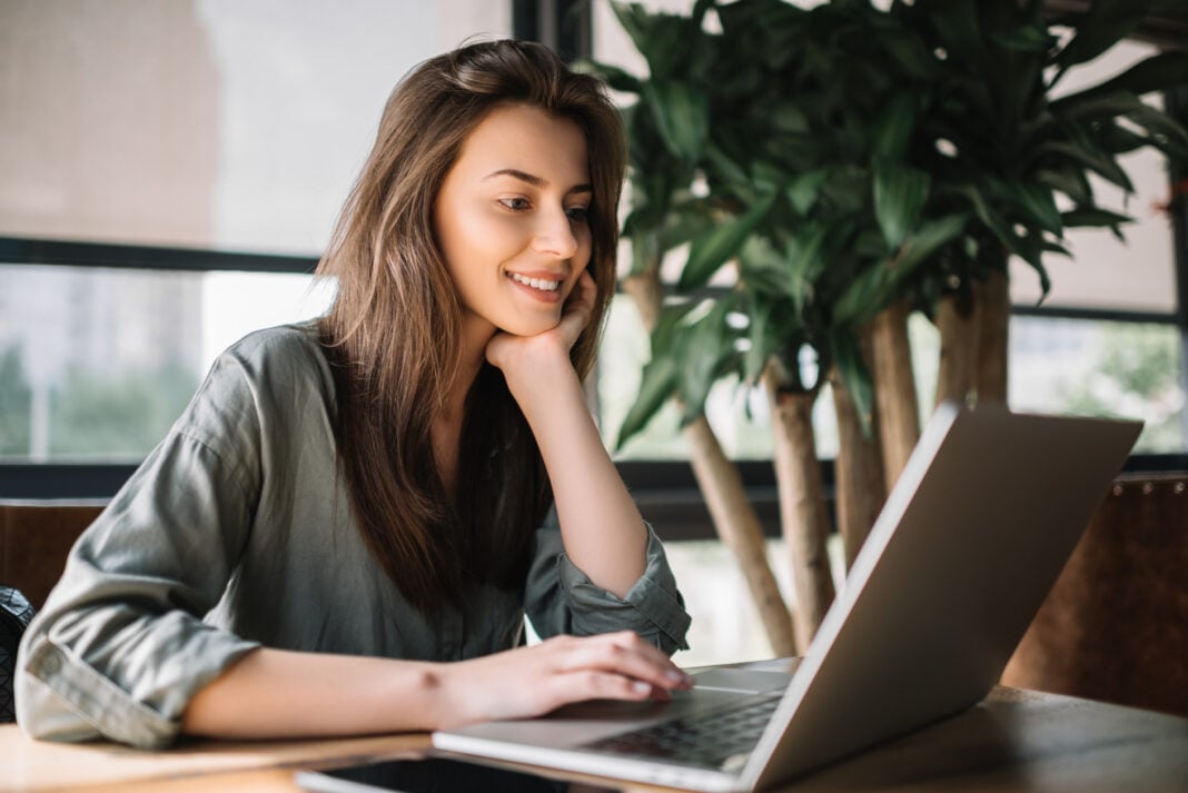 Successful freelancer typing on keyboard using laptop computer