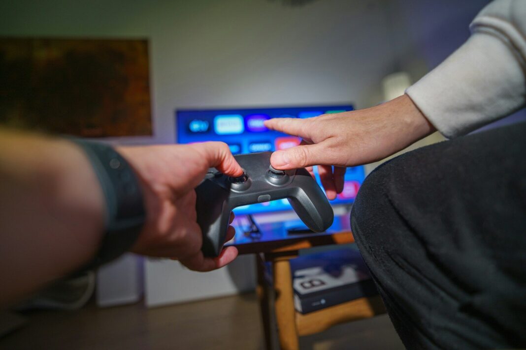 A person holding a video game controller in their hand