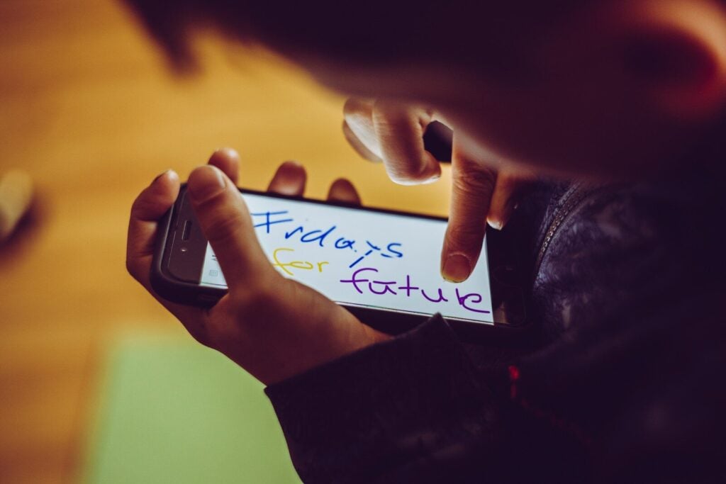 shallow focus photo of person using smartphone
